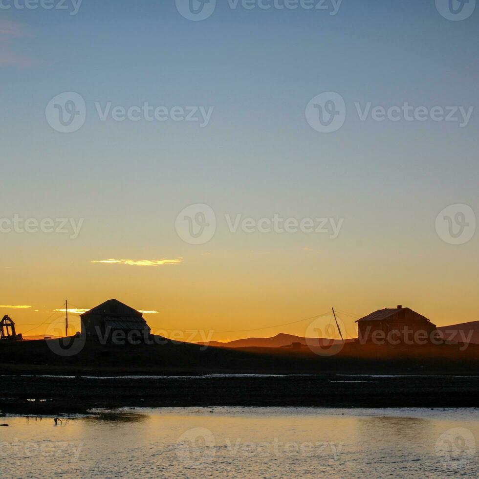 Sunset against the backdrop of wooden houses on the island photo