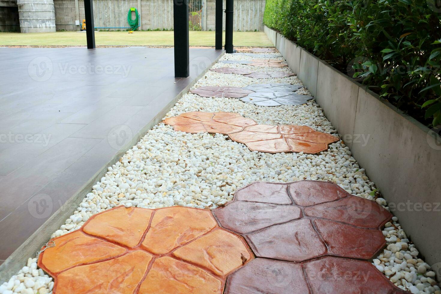 Walk way made frome cobblestone beside brown floor, flowers shape cobblestone colorful way, Thailand. photo
