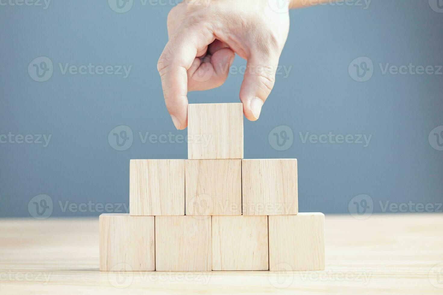 hand of a businessman stacking wood empty eight blocks with copy space for text or symbols, development concept for growth success process. photo