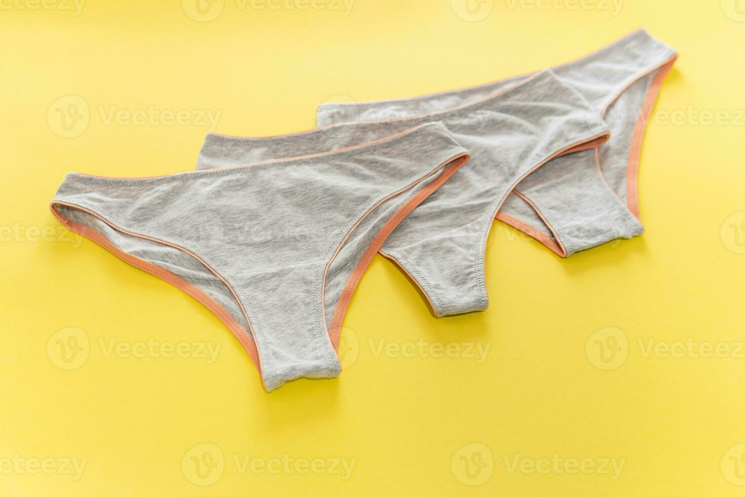 Set of colorful underpants on yellow background, close up photo