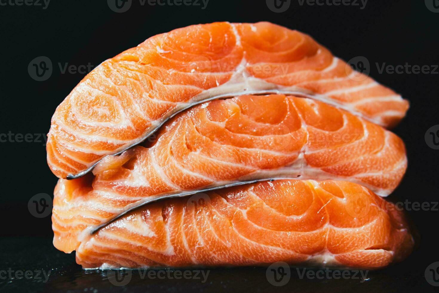 Fresh raw salmon fillet with seasonings and herbs photo