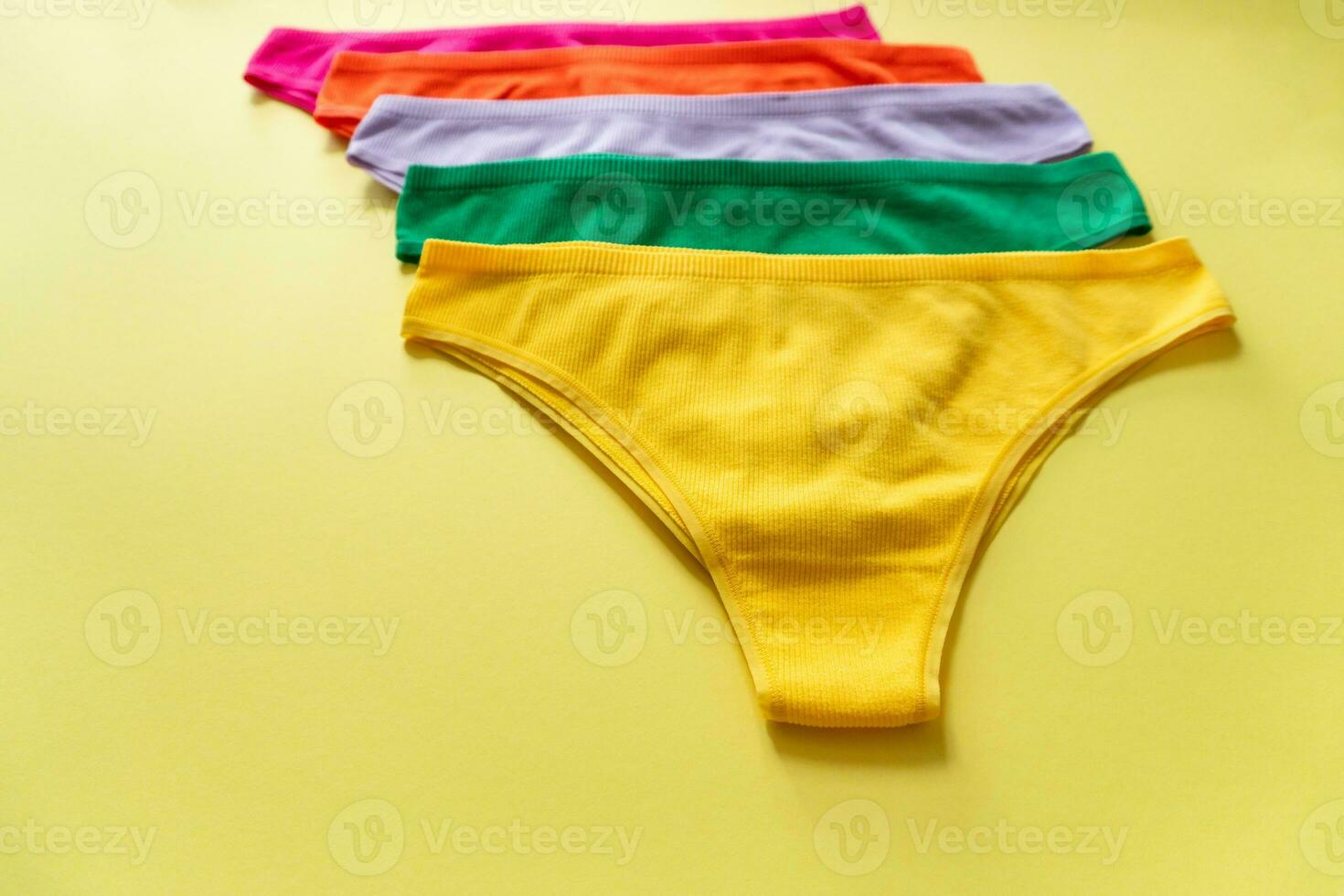 Set of colorful underpants on yellow background photo
