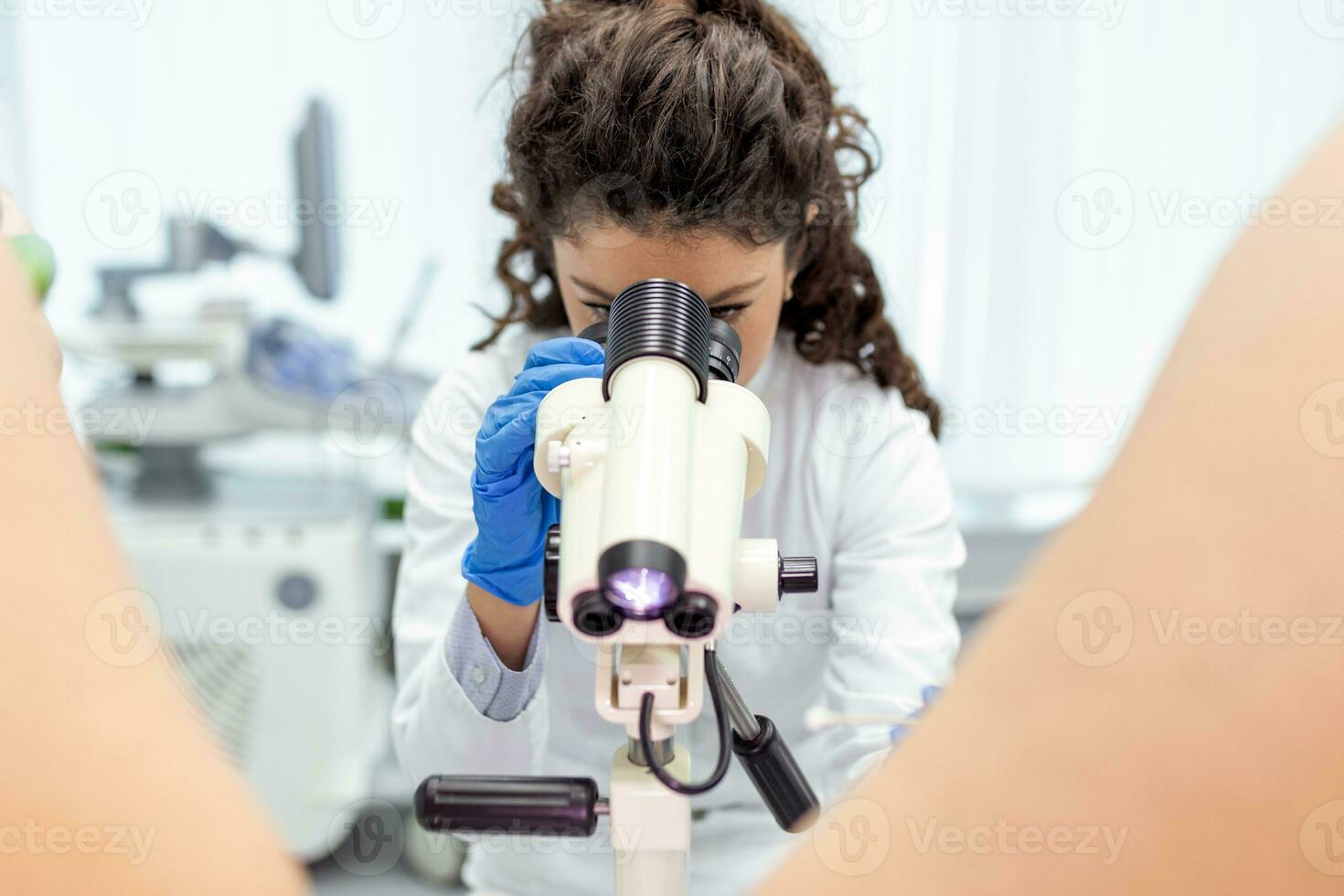 Close up of a female doctor professional gynecologist examining her patient on a gynecological chair healthcare medicine feminine gynecology concept. photo