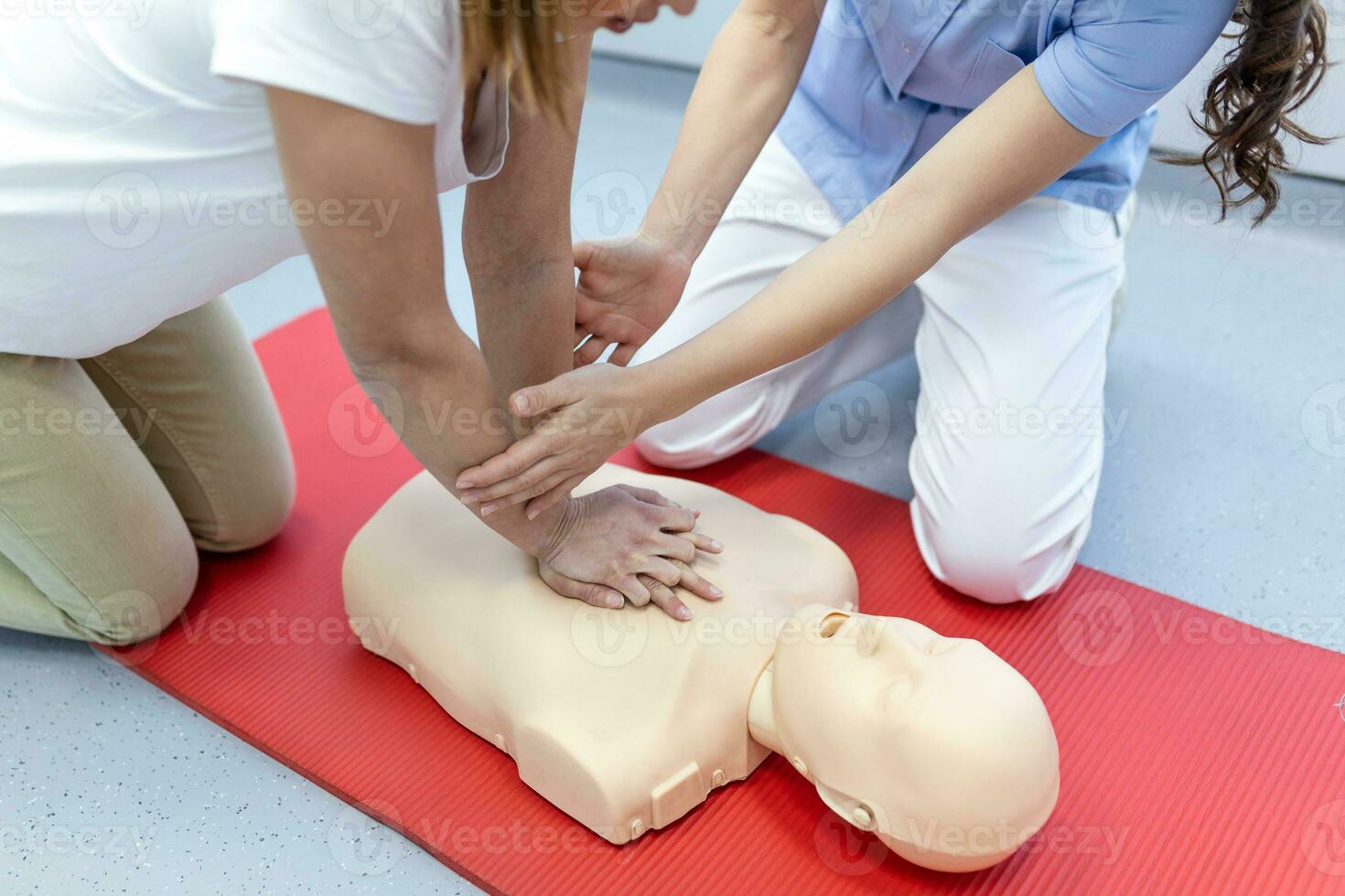 Nursing students are learning how to rescue the patient in emergency. CPR training with CPR doll. Closed-up. Soft focus. photo