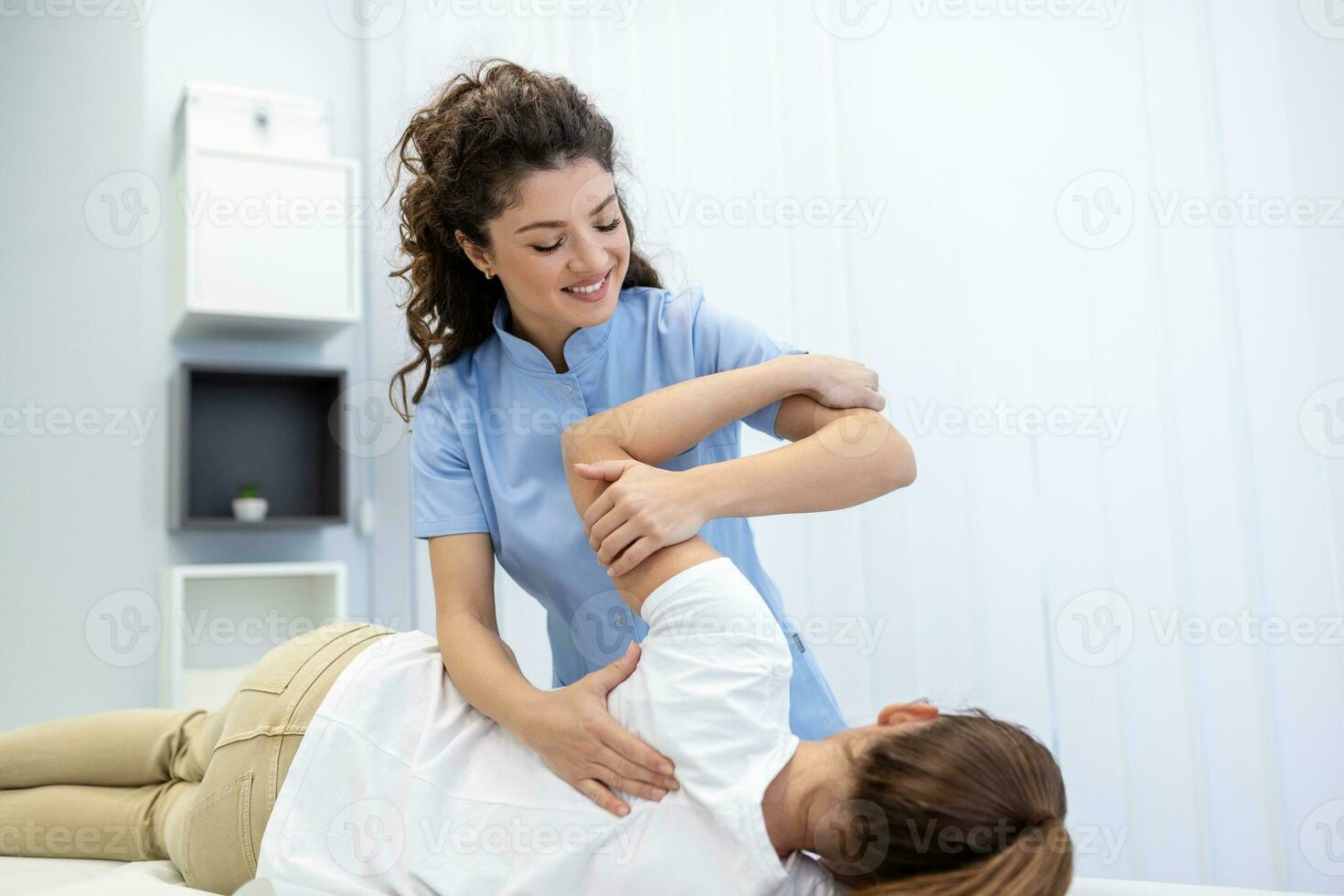 Physiotherapist treatment patient. Holding patient's hand, shoulder joint treatment. Physical Doctor consulting with patient About Shoulder muscule pain problems Physical therapy diagnosing concept photo