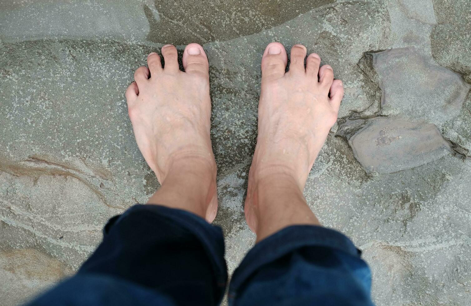 Dirty and wet woman Barefoot on rock concrete floor. photo