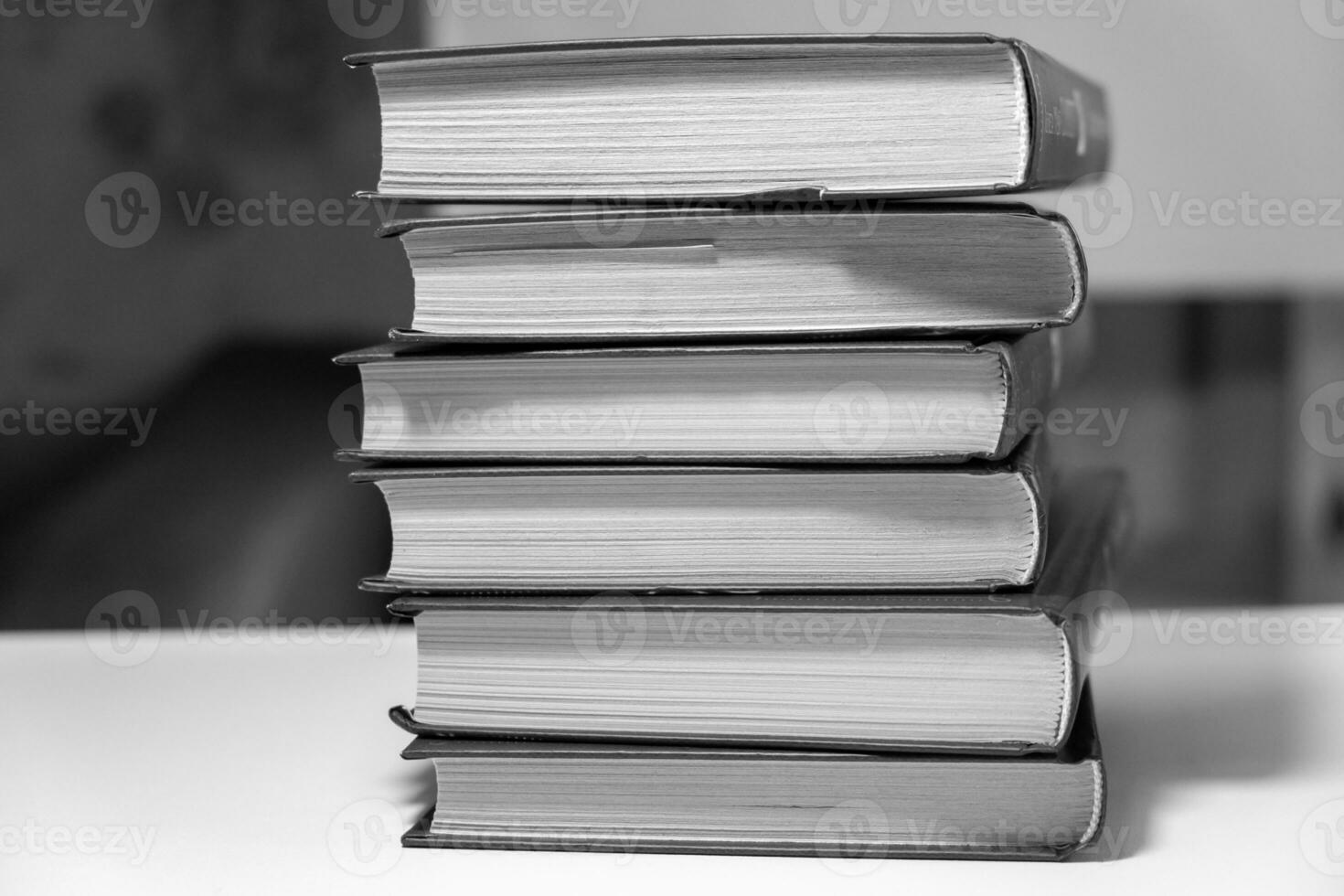 Stack of books on a white background. One book is yellow. photo