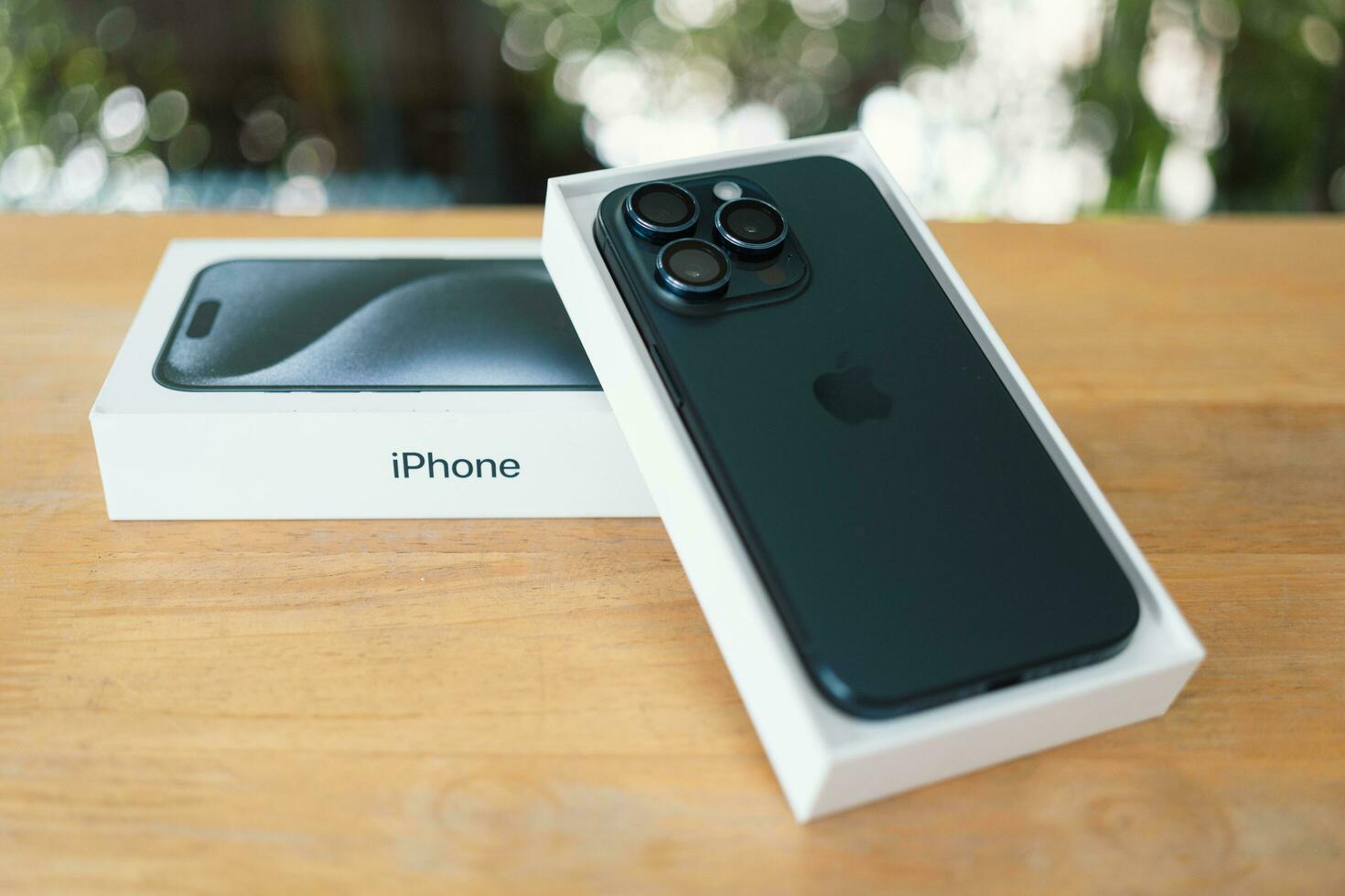 Bangkok, Thailand - October 27, 2023 Back view of new iPhone 15 Pro Titanium Blue, lies face down in a box. photo