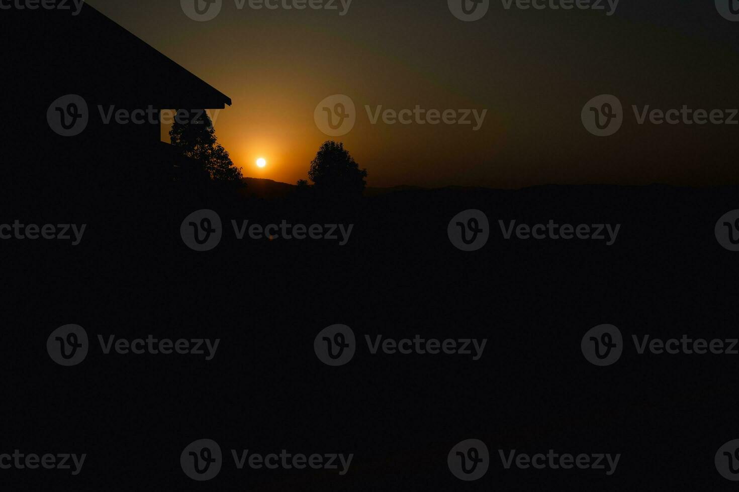 Beautiful landscape nature tree and home on the sunset on the mountains photo