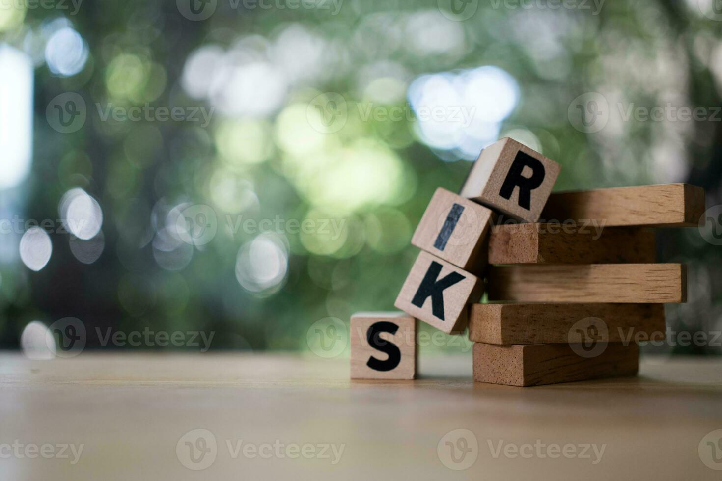 Wood block of text RISK falling. Risk Management and insurance concept photo