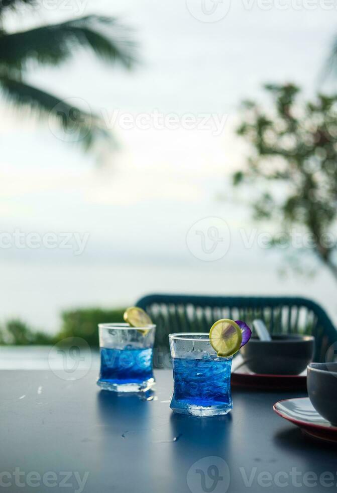 Summer fresh drink butterfly pea drink and slice of lime with empty bowl on table dinner photo