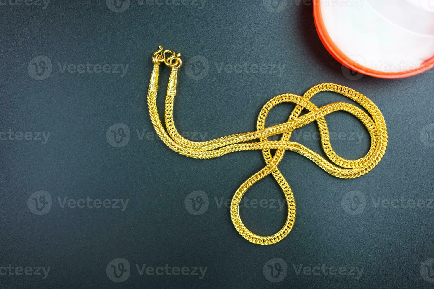 Gold chain on a black backgroun photo