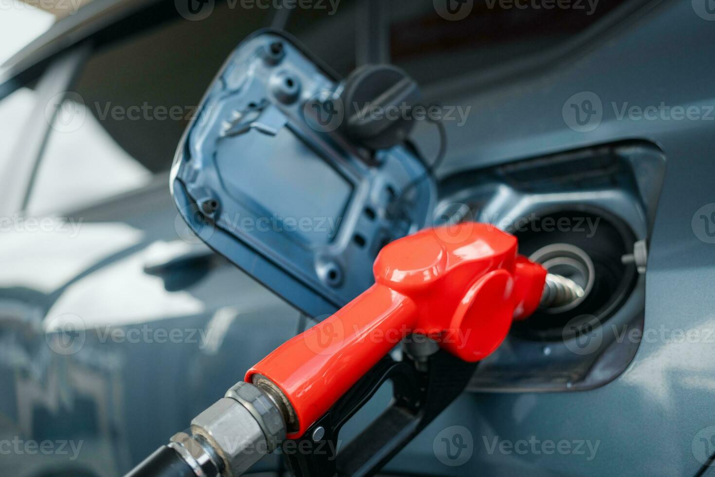 Refilling the car with fuel. Blue car refueling at a petrol station. photo