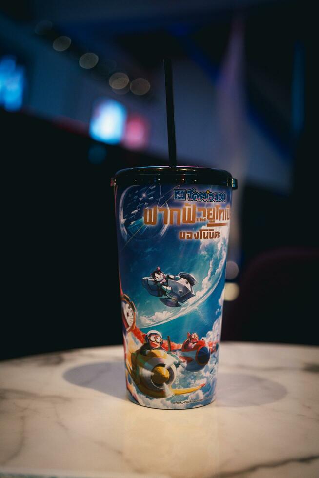 Bangkok, Thailand - October 11, 2023 A cup with the pattern Doraemon The Movie 2023 Nobita's Sky Utopia from Major Cineplex. photo