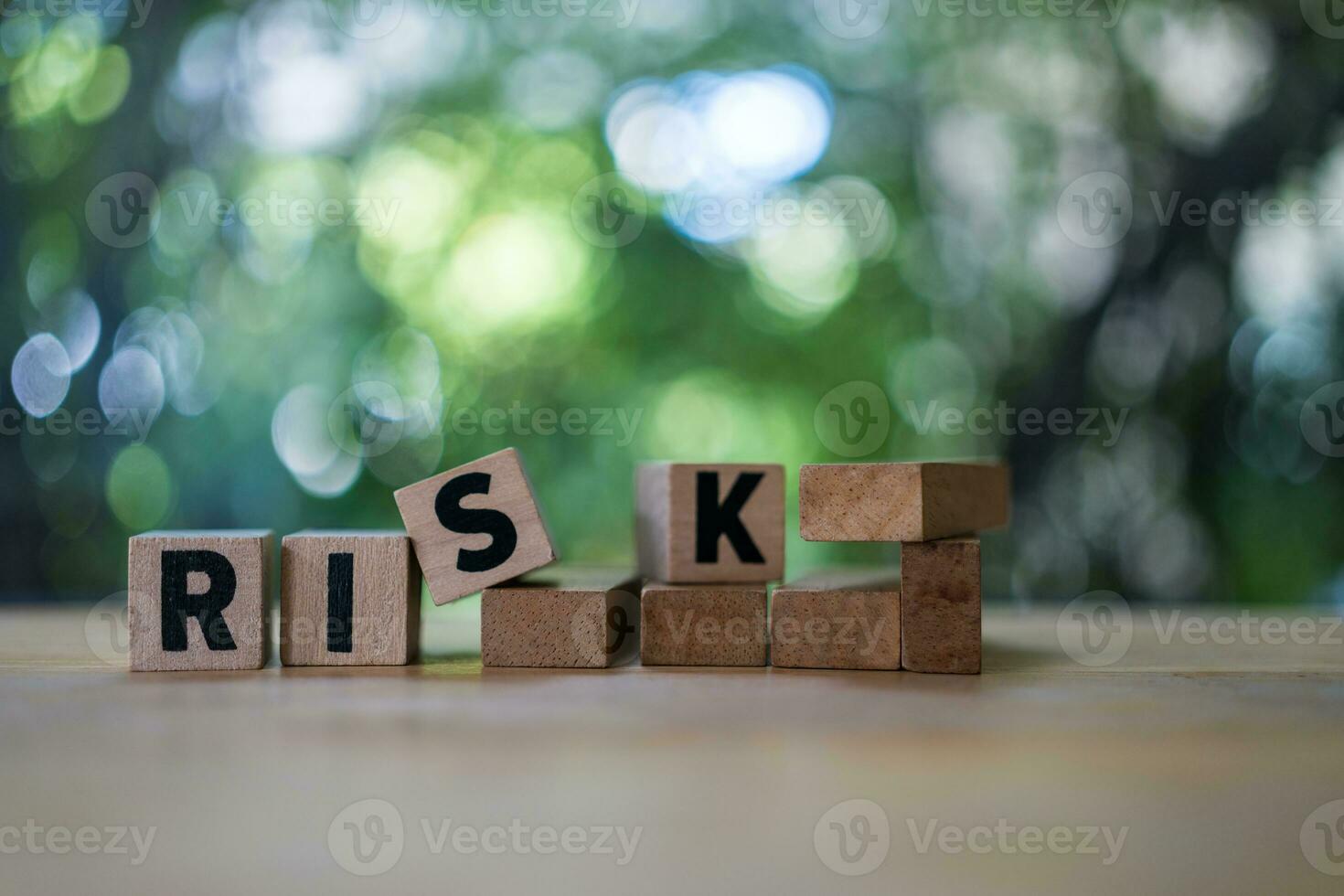 Four wood cubes with black letters spelling RISK. Risk Management photo