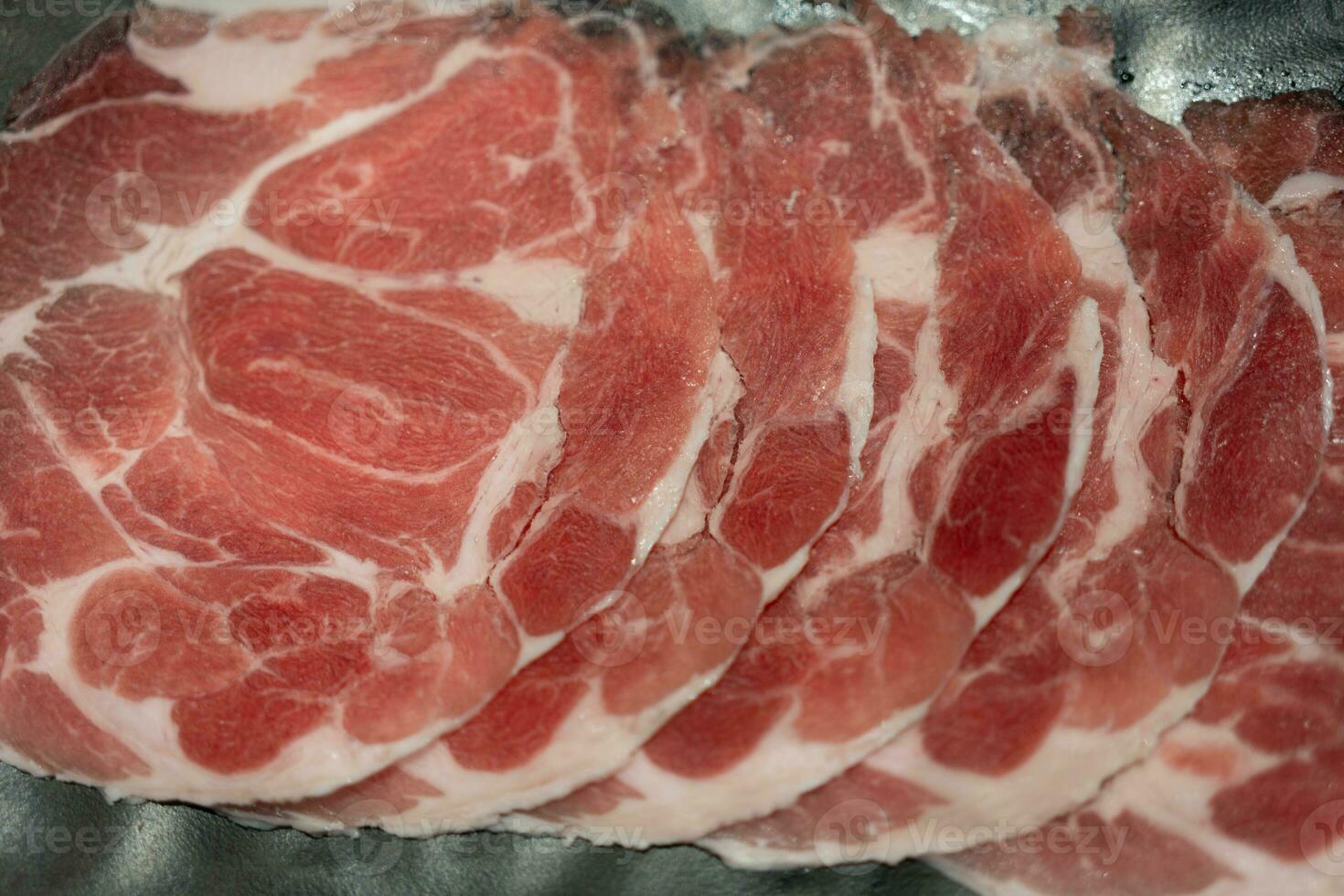 Rare sliced raw beef with marbled texture photo