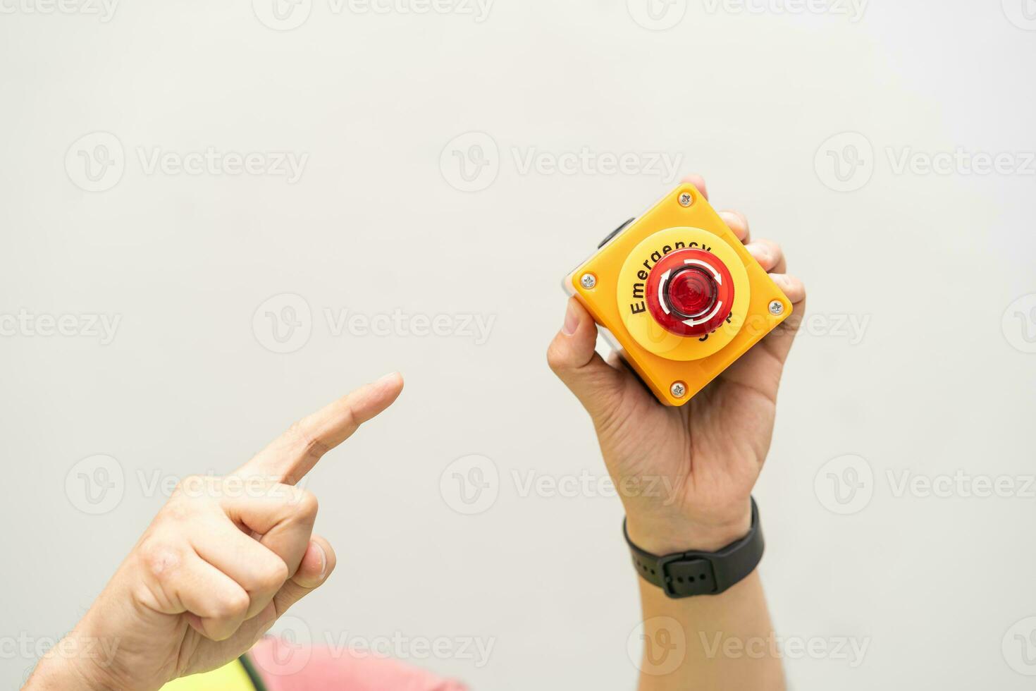 Engineer pressing an emergency stop button with copy space. Industrial working operating process. Stop Switch machine malfunctioning for safety. photo