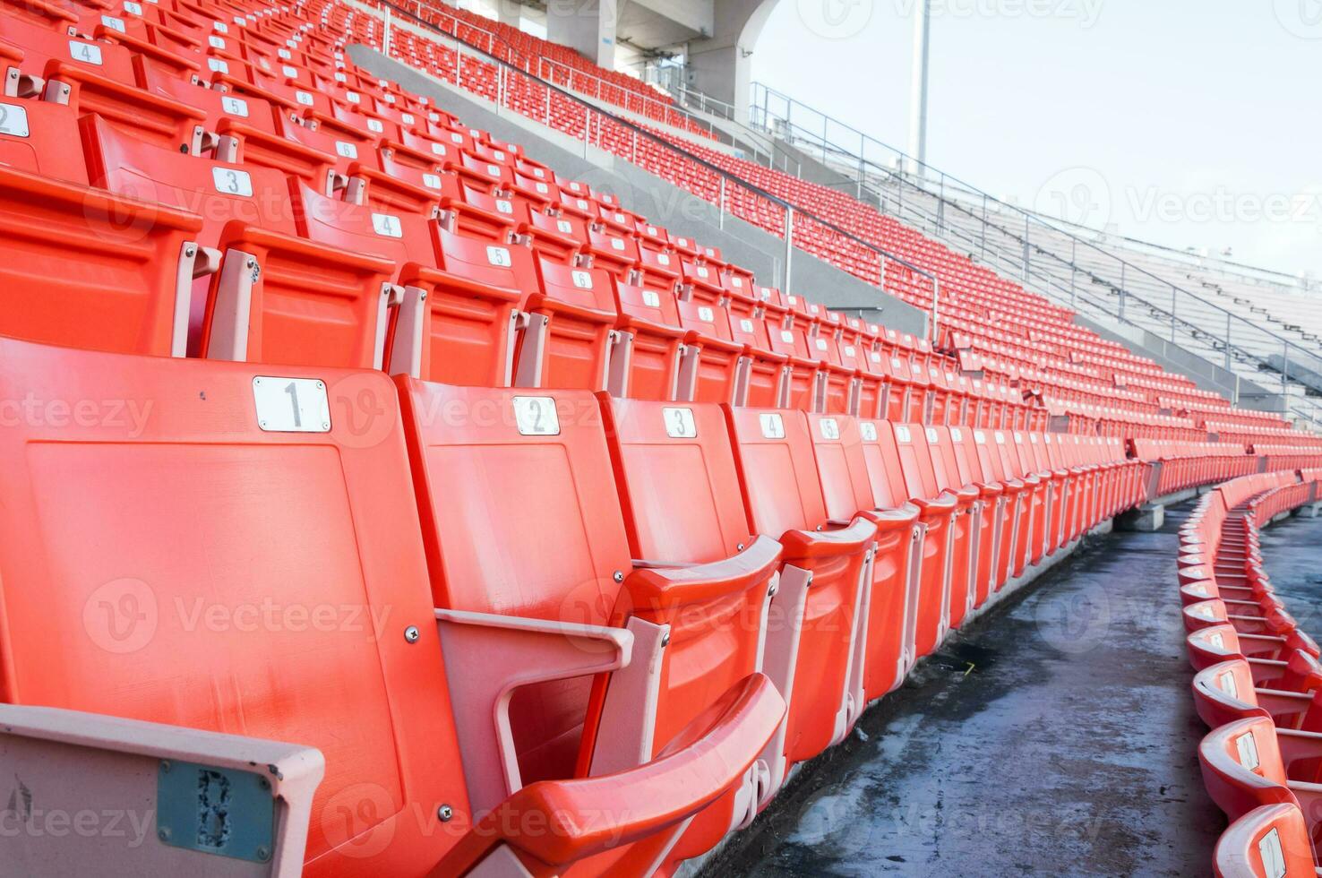 Empty orange seats at stadium,Rows of seat on a soccer stadium photo