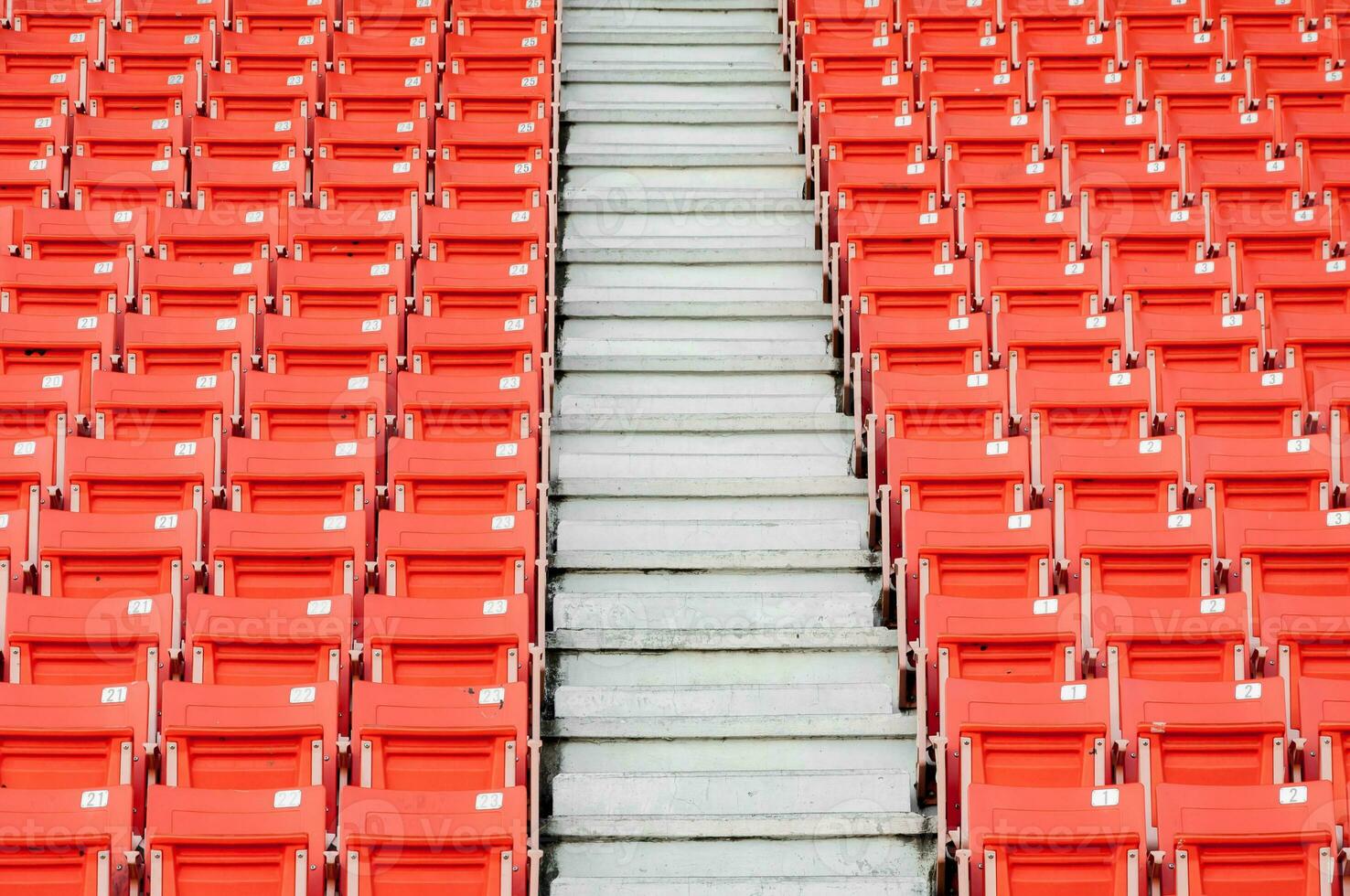 Empty orange seats at stadium,Rows of seat on a soccer stadium photo