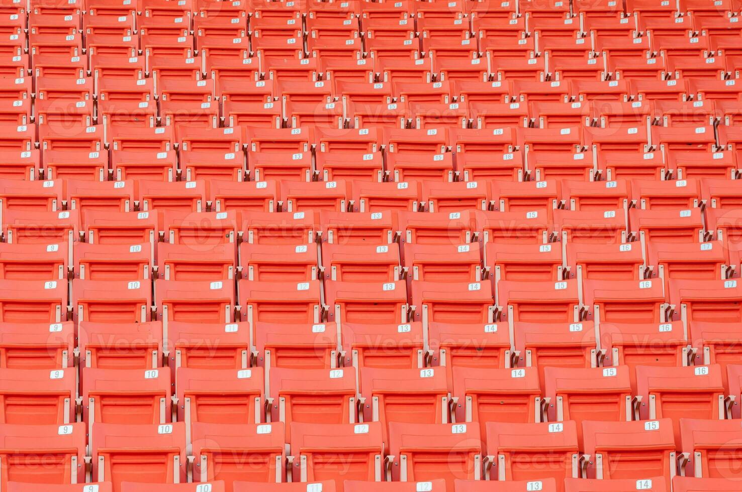 Empty orange seats at stadium,Rows of seat on a soccer stadium photo