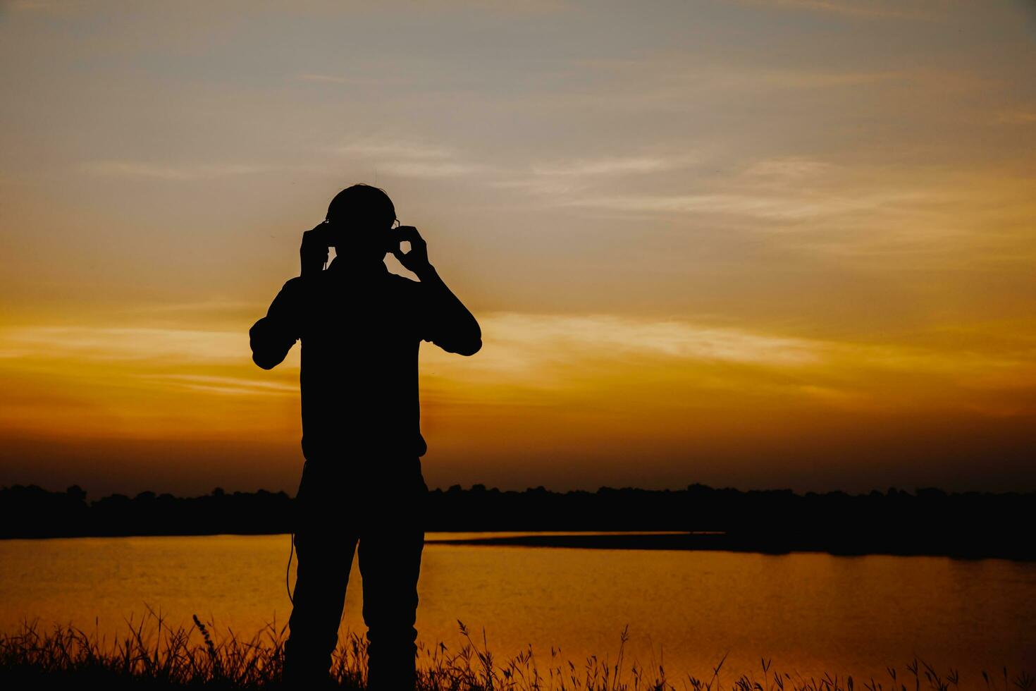 Male tourists standing by the telethon at sunset. photo