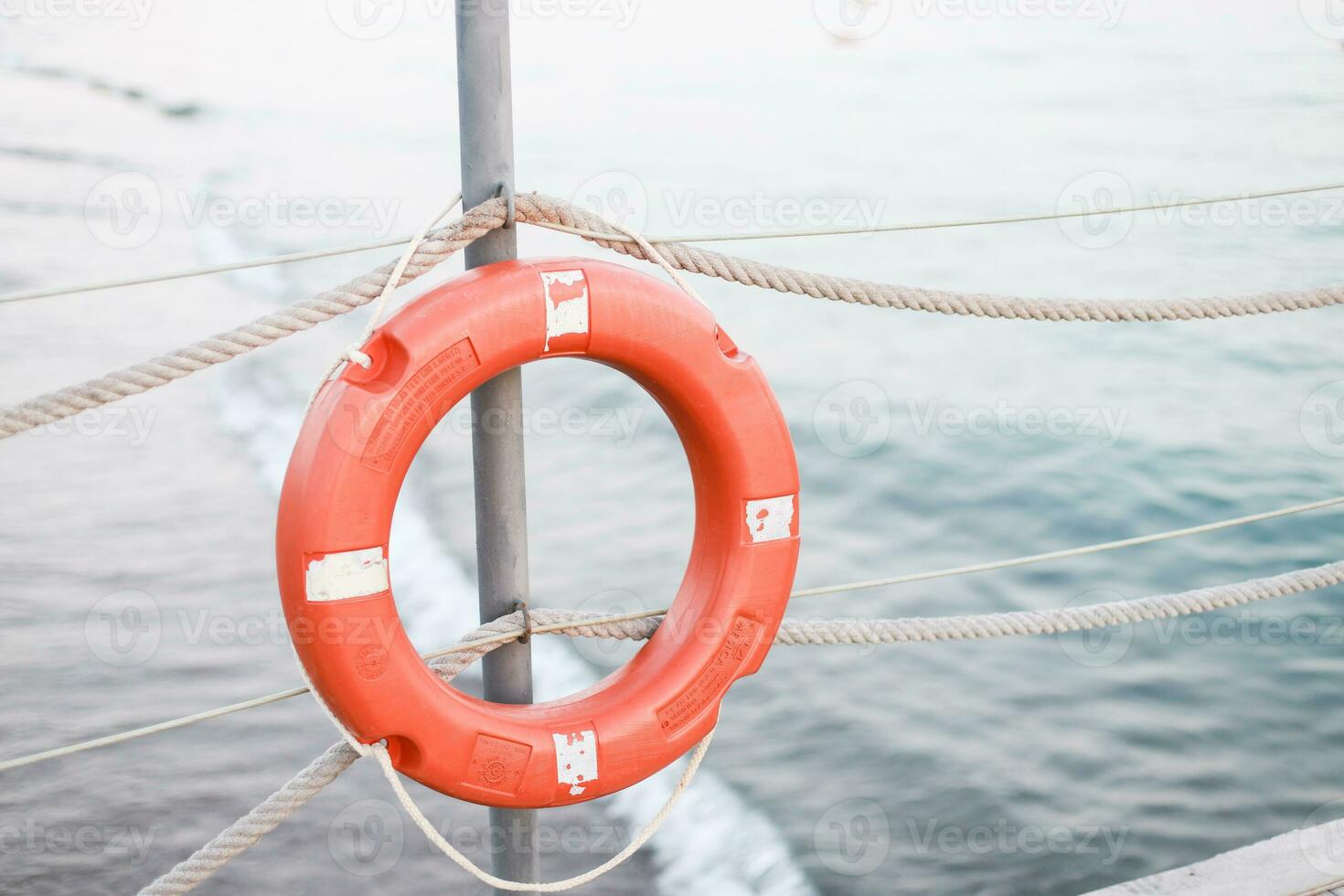 A life jacket hangs on the beach. Orange life jacket photo