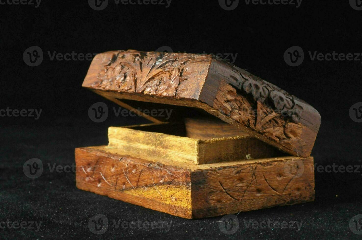a small wooden box with carved designs on it photo
