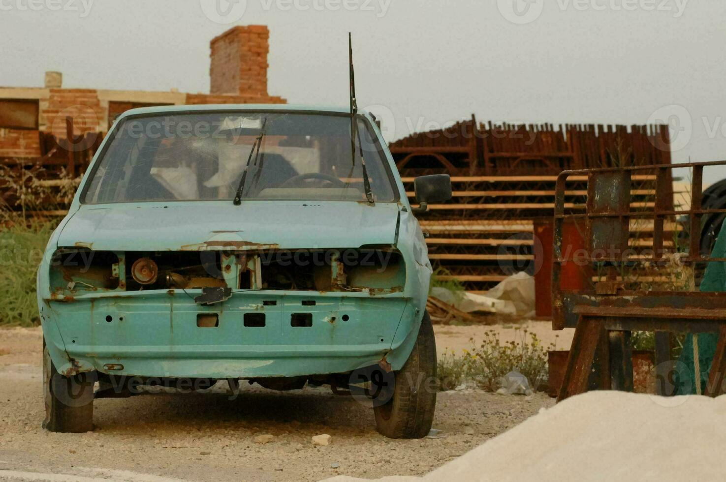 a blue car is parked in front of a building photo