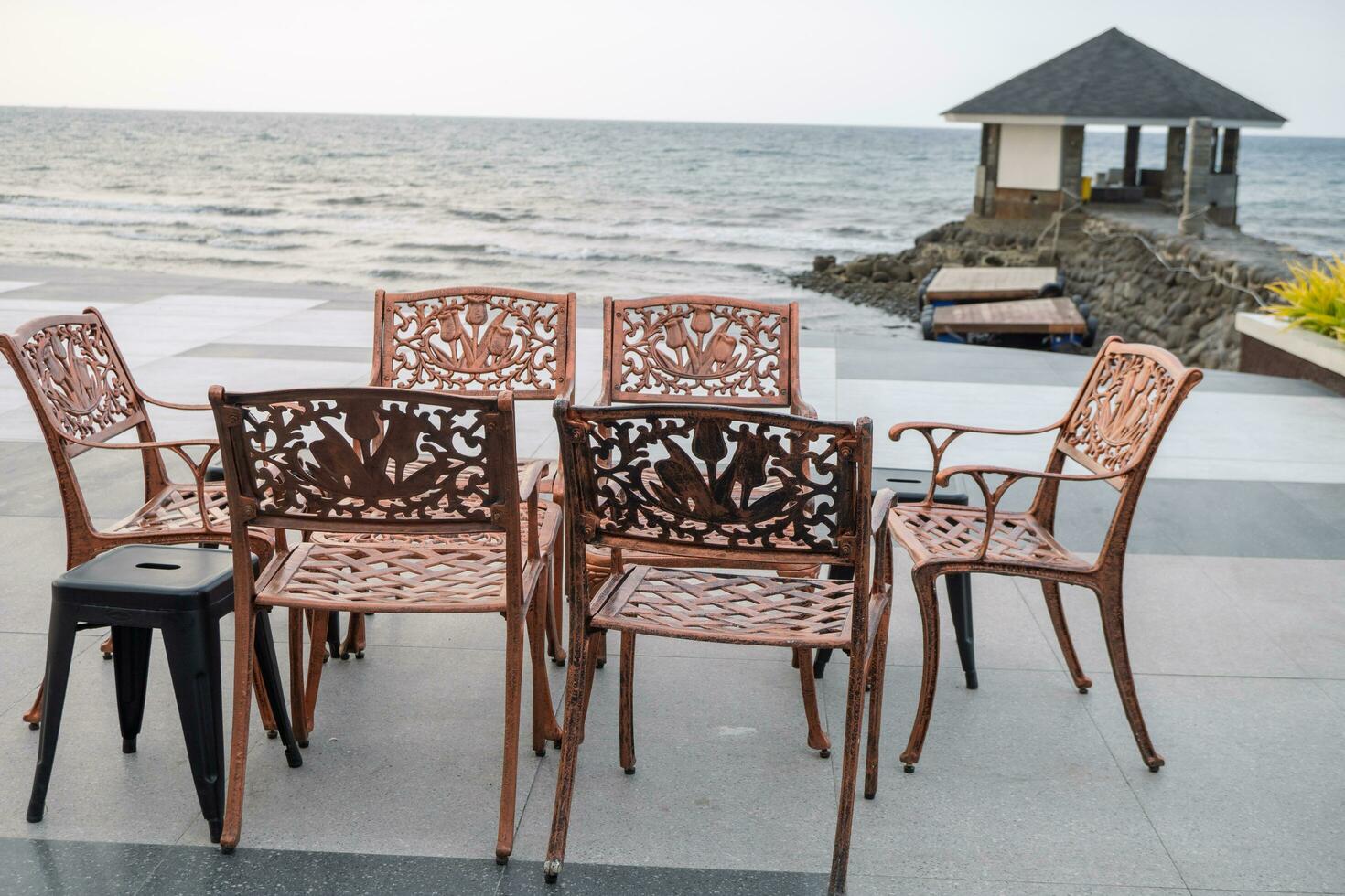 Empty chair and table with beautiful background and cloudy sky on the restaurant. The photo is suitable to use travel destination, holiday and vacation content media.