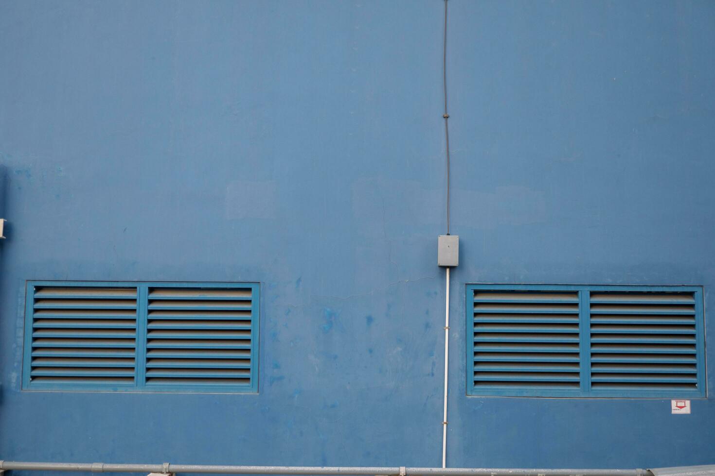 Blue windows air ventilation on power plant building. The photo is suitable to use for architect content media and building background.