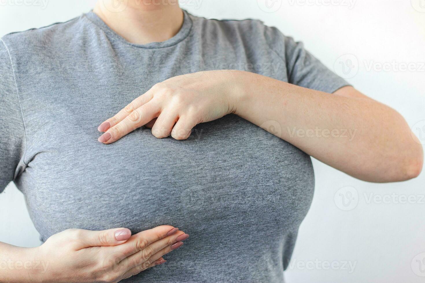 Young woman doing breast self-diagnosis. Breast Cancer Awareness Month. Women's health care photo