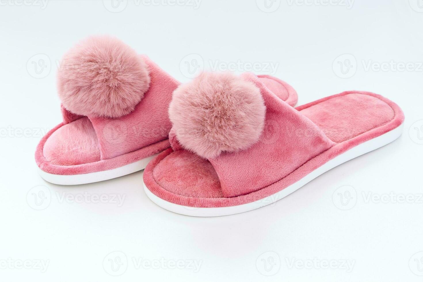Pink home fluffy slippers on white background photo