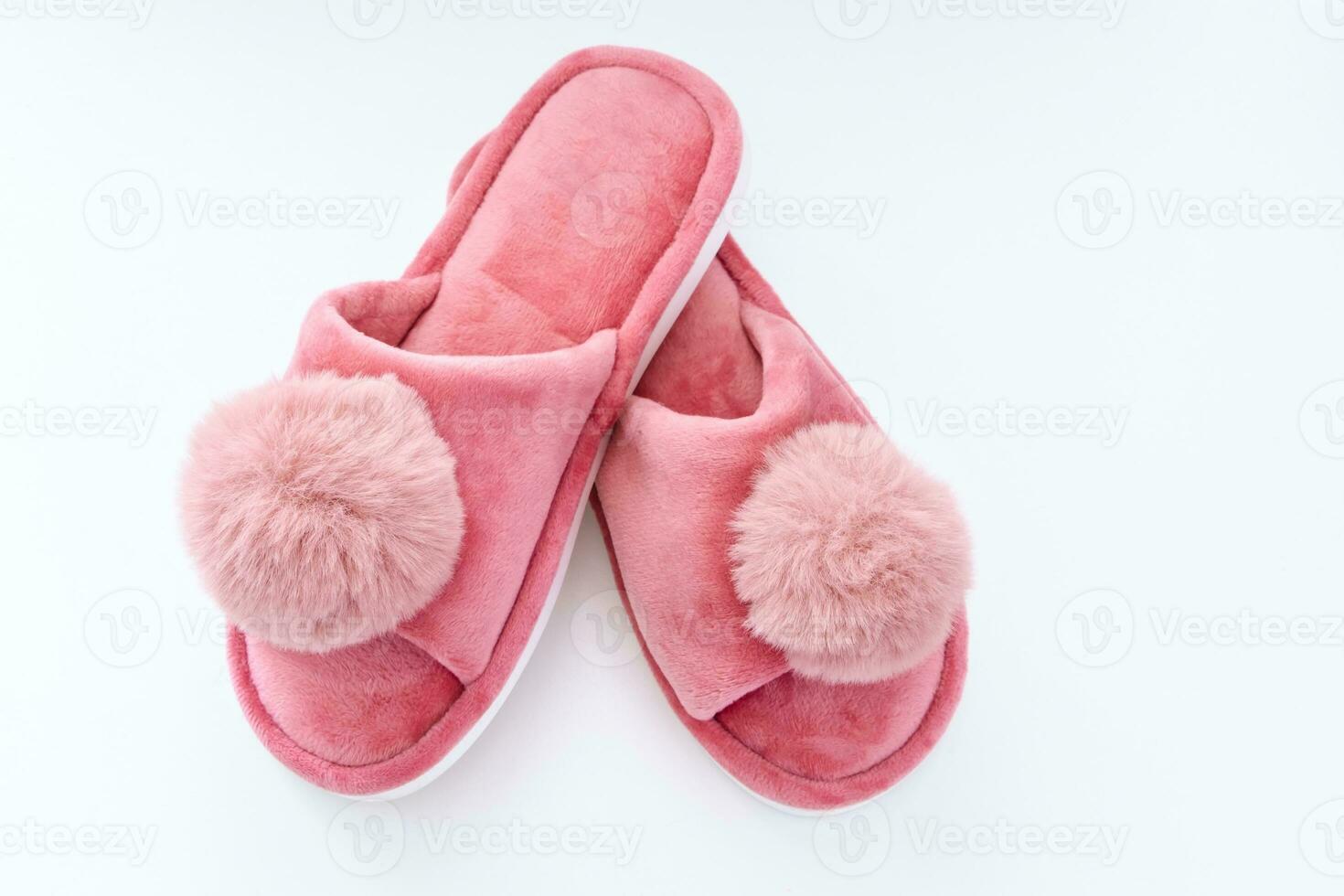 Pink home fluffy slippers on white background photo