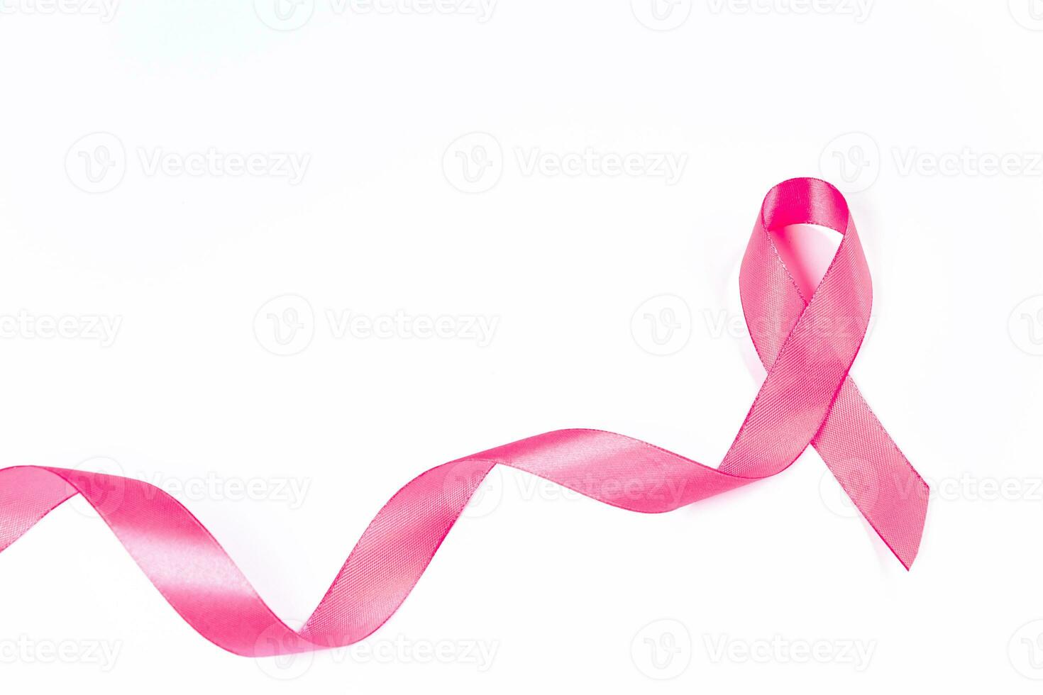 Pink ribbon on white background. Breast Cancer Awareness Month. Women's health care concept. Symbol of hope and support. photo