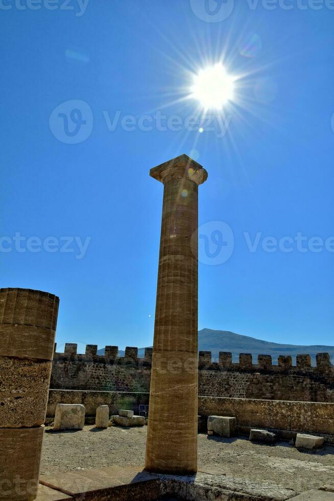 old antique stone ruins on a hot summer day on the Greek island of Rhodes in Lindos photo