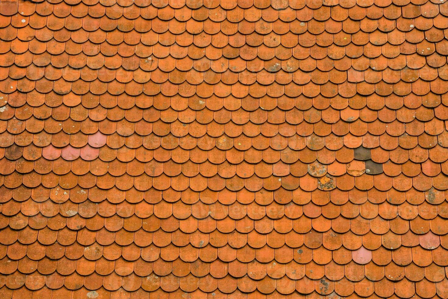 an orange roof with many different colored tiles photo