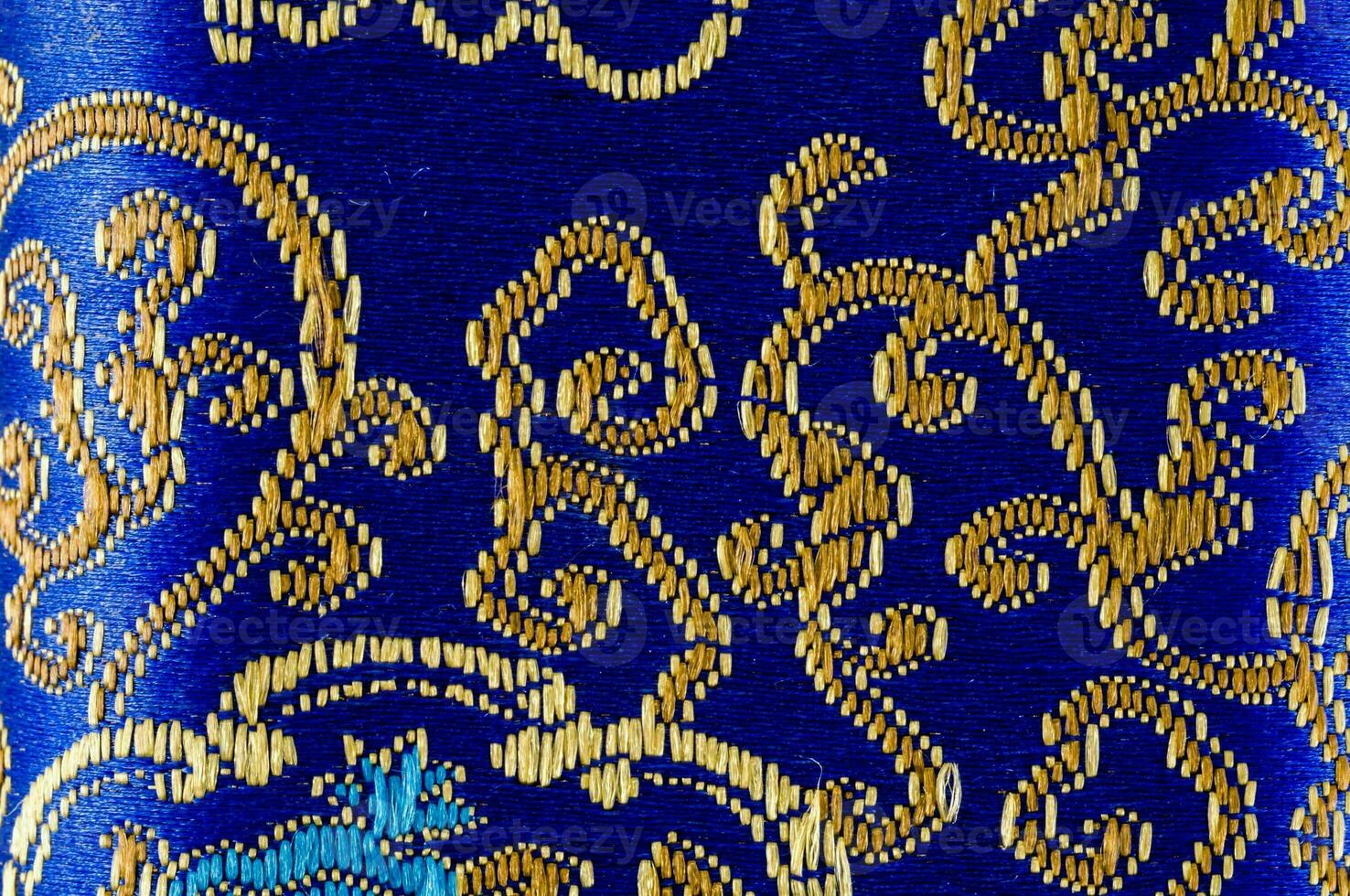 a blue and gold patterned fabric with a cat on it photo