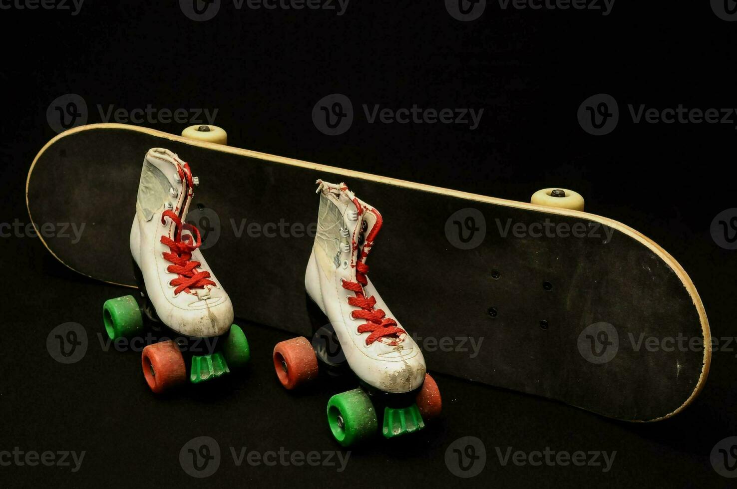 two roller skates on a black background photo