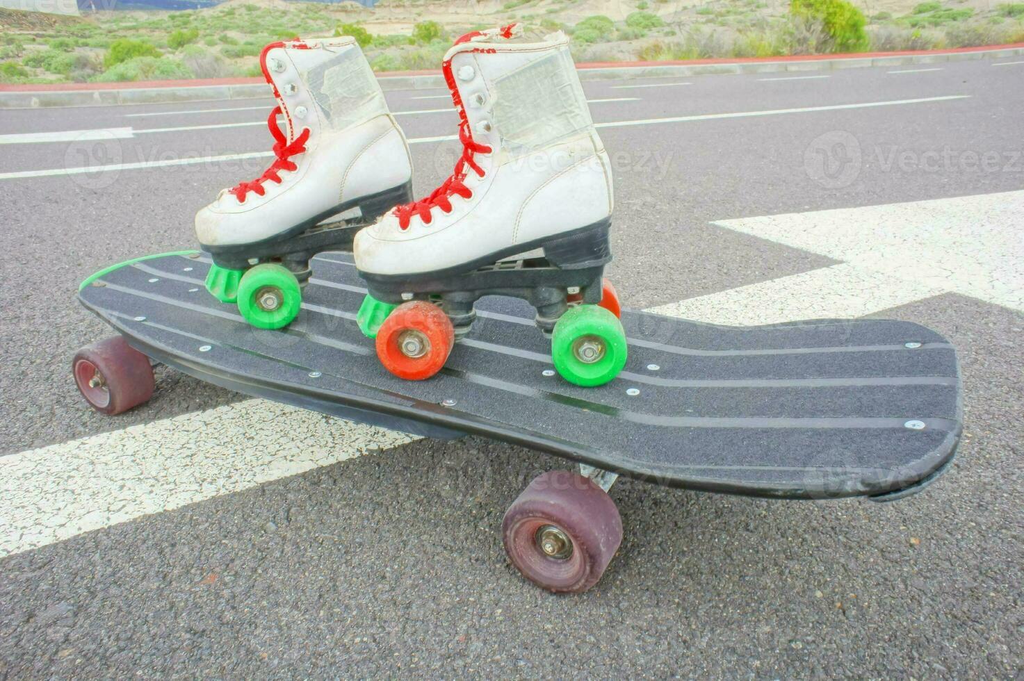 two roller skates on top of a skateboard photo