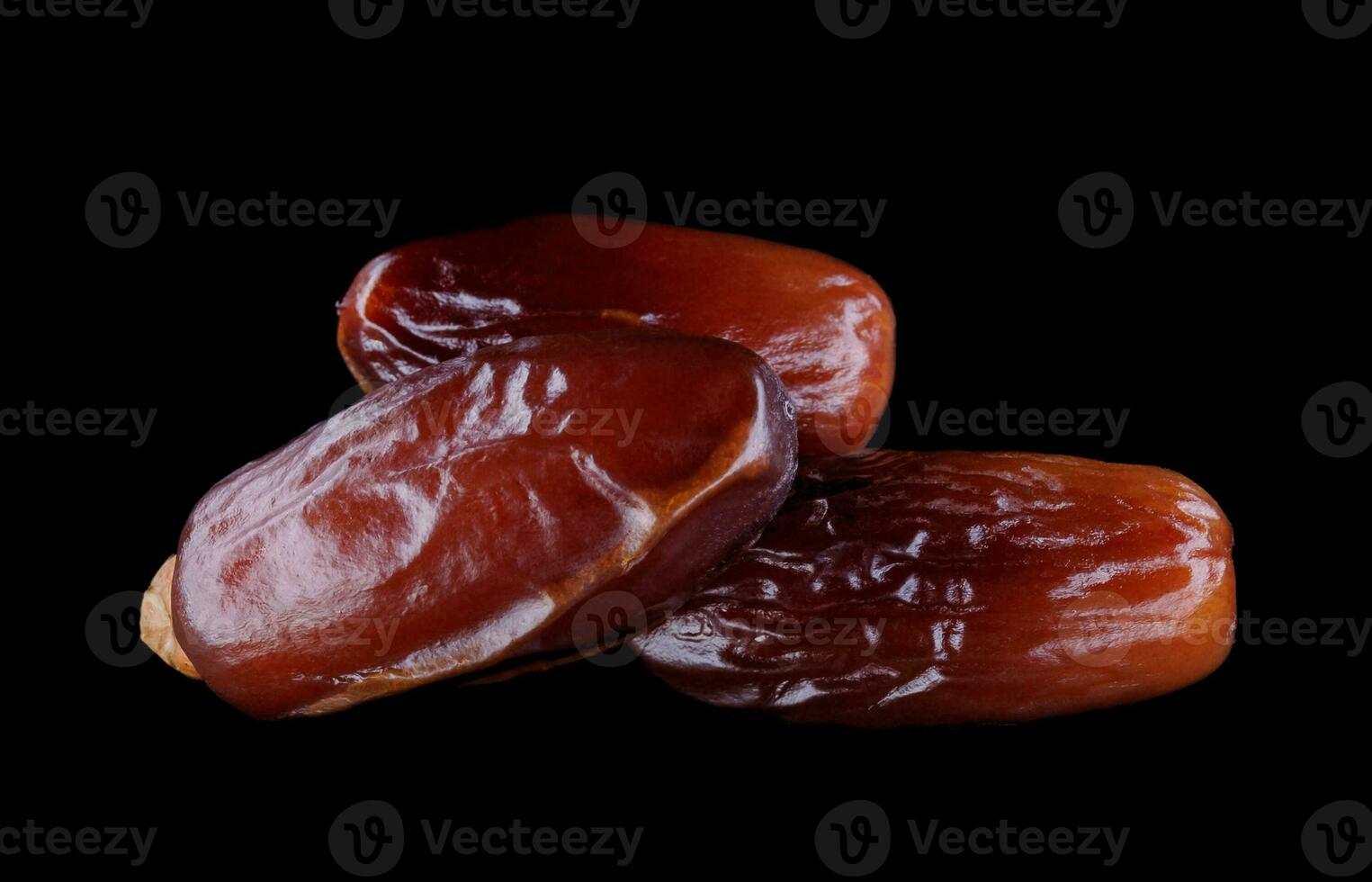 Several ripe dates on a black background. Delicious dates on black. photo