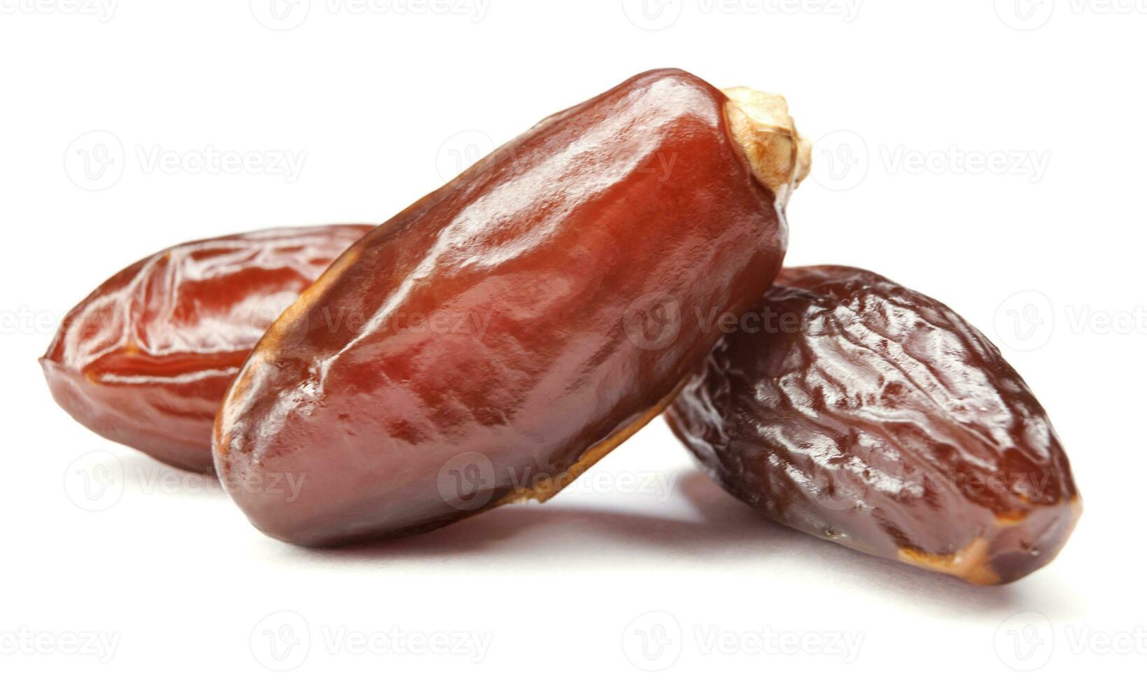 Three ripe dates isolated on a white background. Full clipping path. Dates . photo