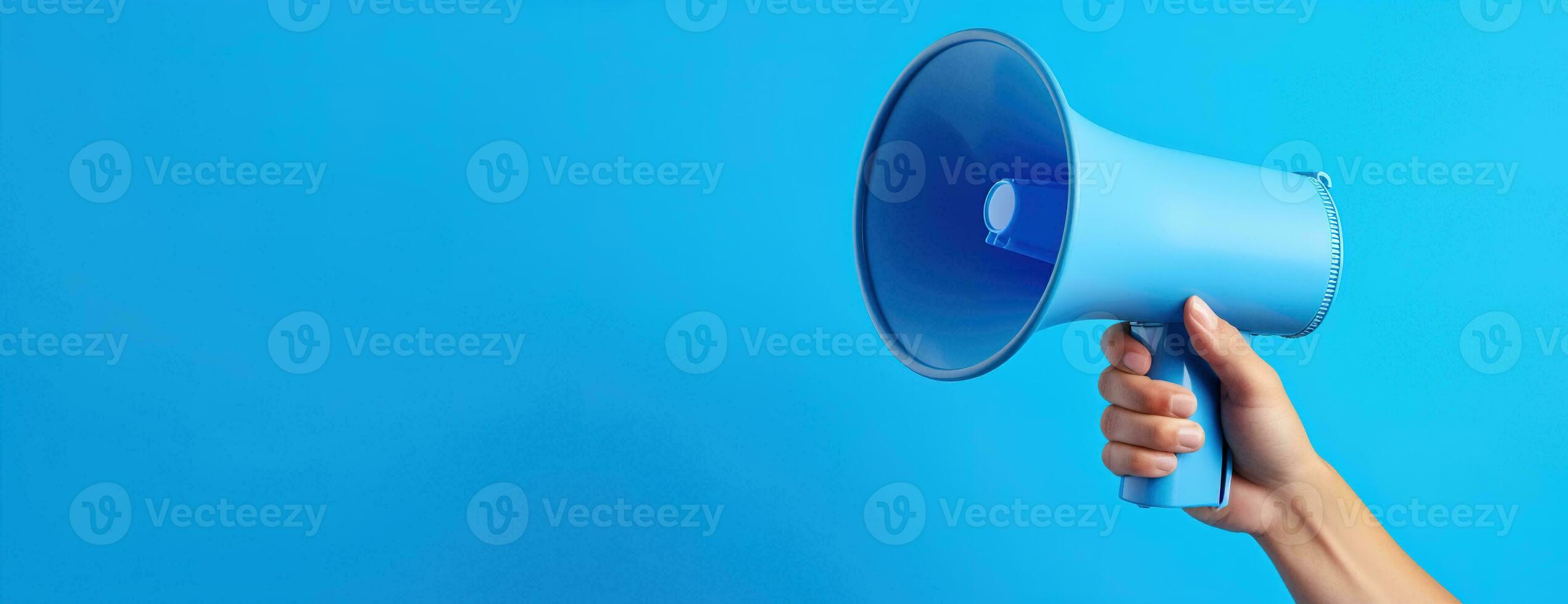 Generative AI, megaphone in hand on a empty blue background, panoramic image with copy space photo