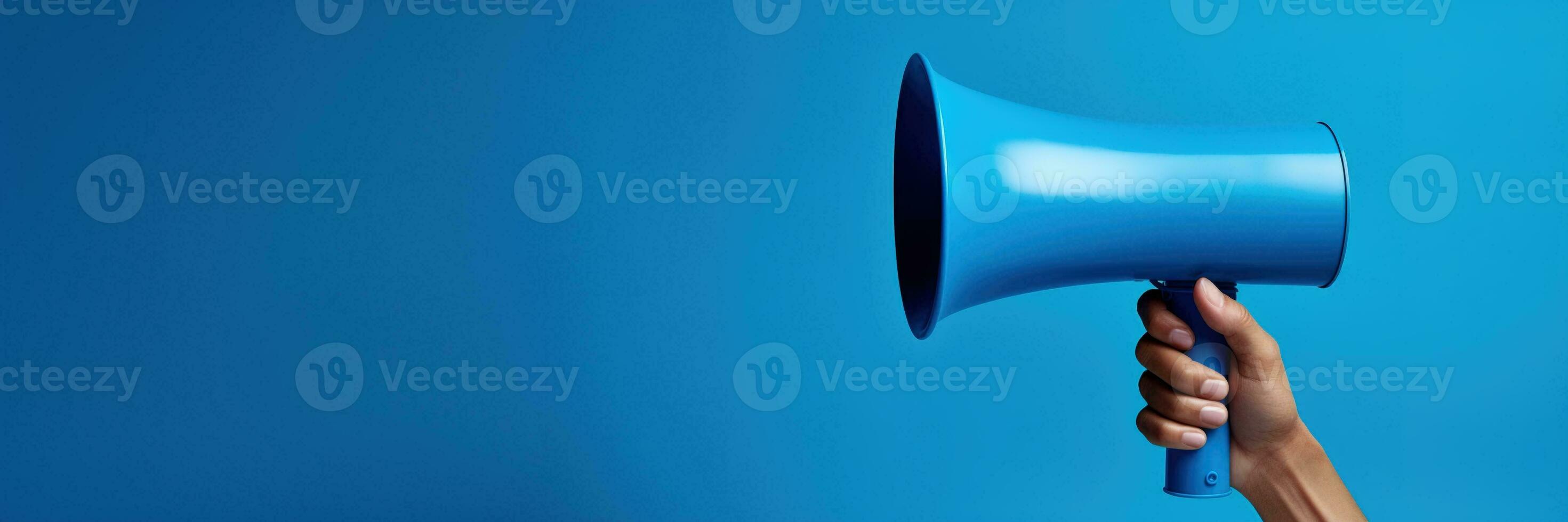 Generative AI, megaphone in hand on a empty blue background, panoramic image with copy space photo