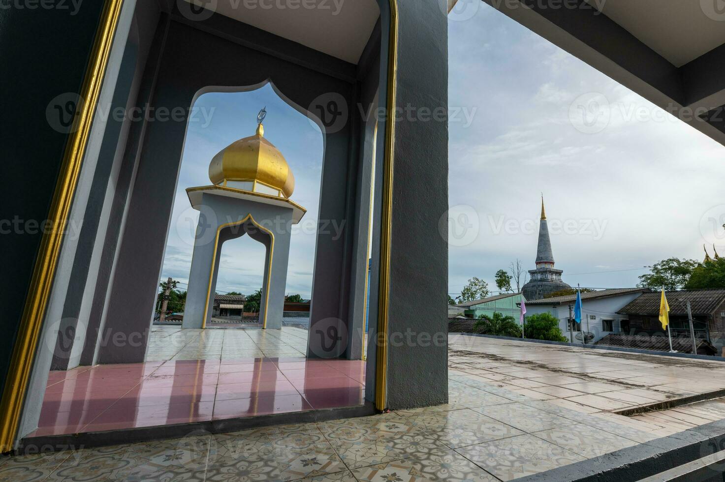 Dome of mosque and pagoda of temple in frame at Nakhon Si Thammarat, Thailand photo