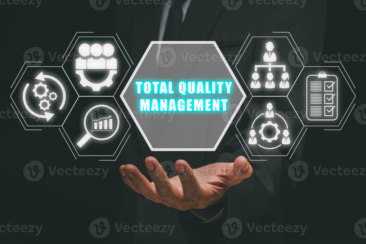 Total quality management concept, Businessman hand holding total quality management icon on virtual screen. photo