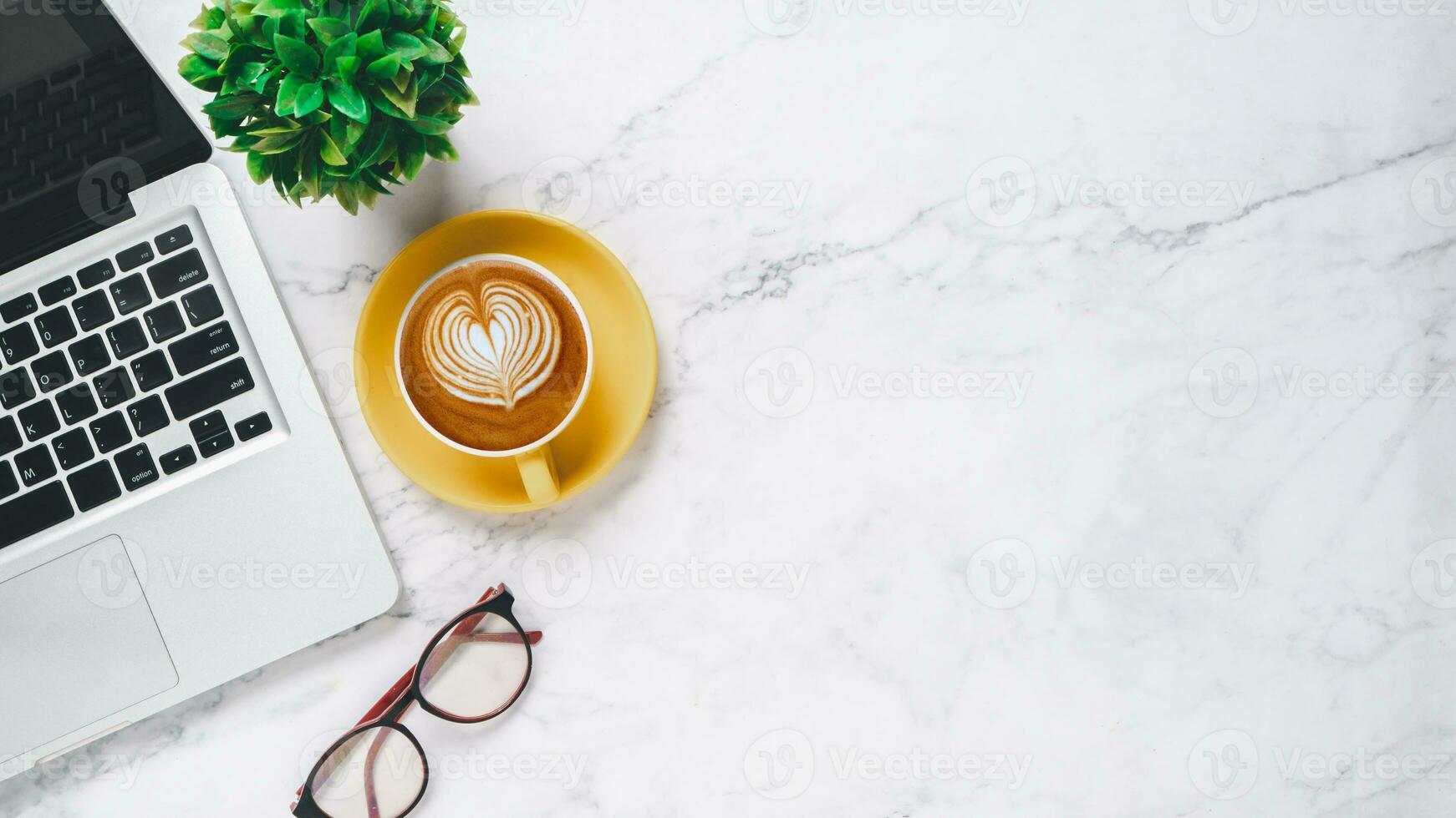 White office desk with laptop computer, eyeglass and cup of coffee, Top view with coprspace, Mock up. photo