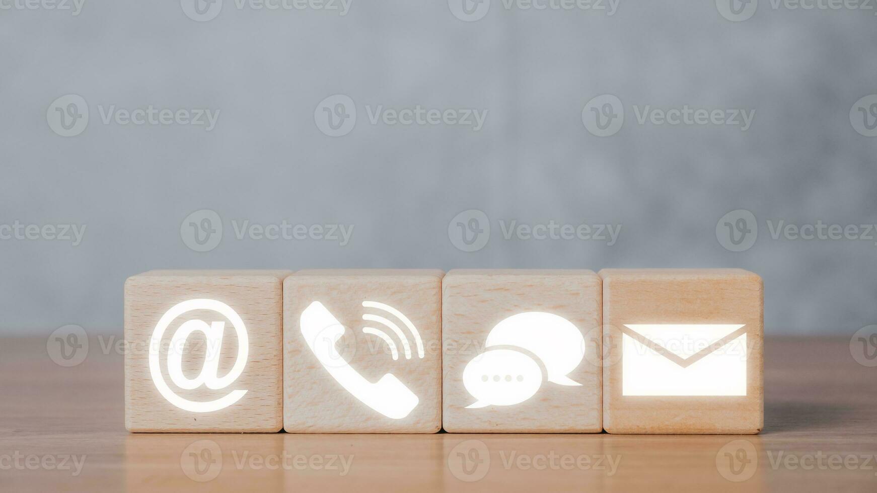 Contact us or Customer support hotline people connect, Wooden blocks with contact us icon on dark background. photo