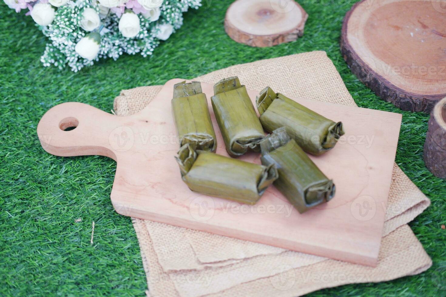 Arem-arem, a traditional food made from rice filled with vegetables, chicken, meat or tempeh wrapped in banana leaves. Arem-arem is popular as a breakfast substitute photo