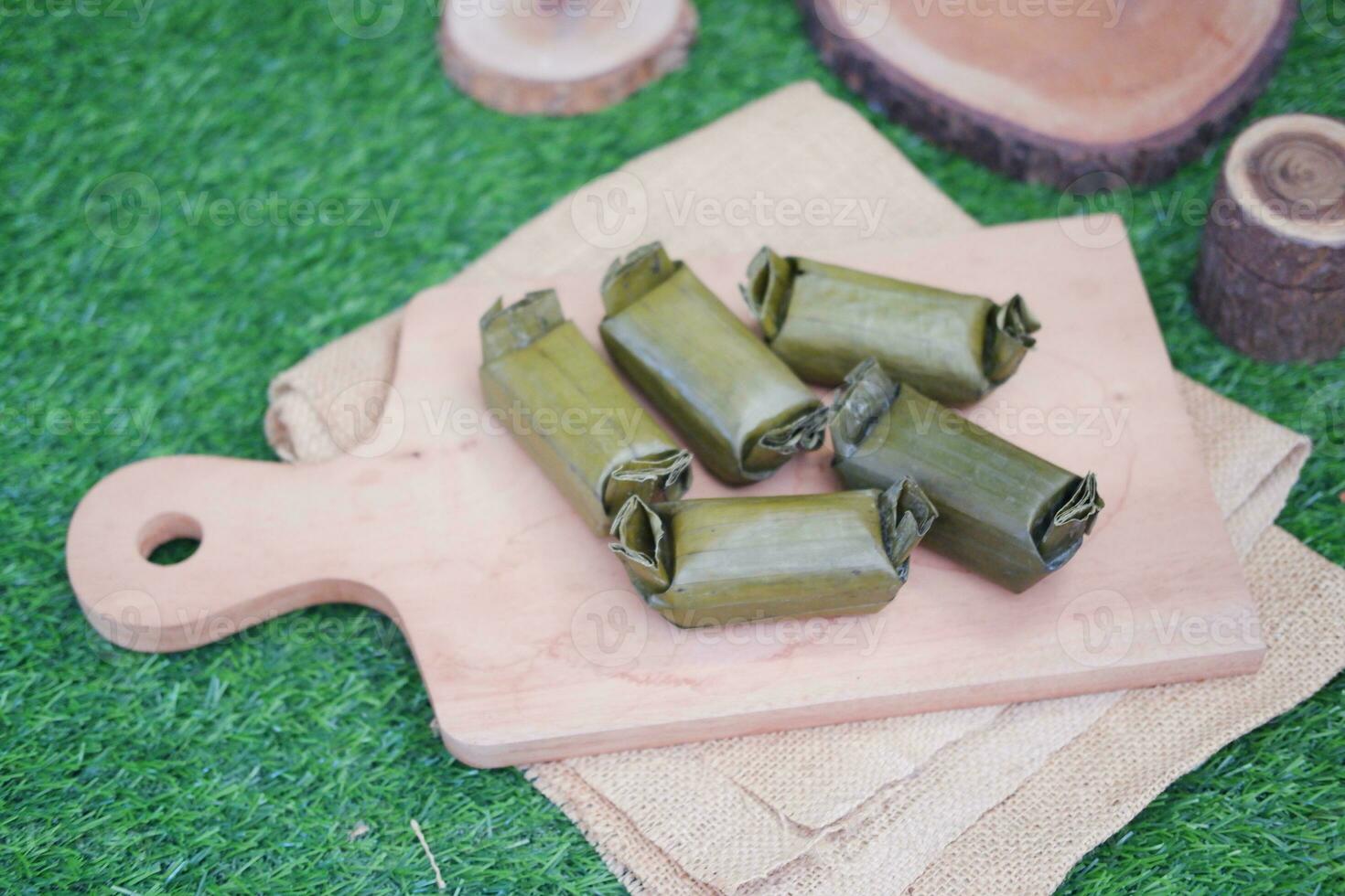 Arem-arem, a traditional food made from rice filled with vegetables, chicken, meat or tempeh wrapped in banana leaves. Arem-arem is popular as a breakfast substitute photo