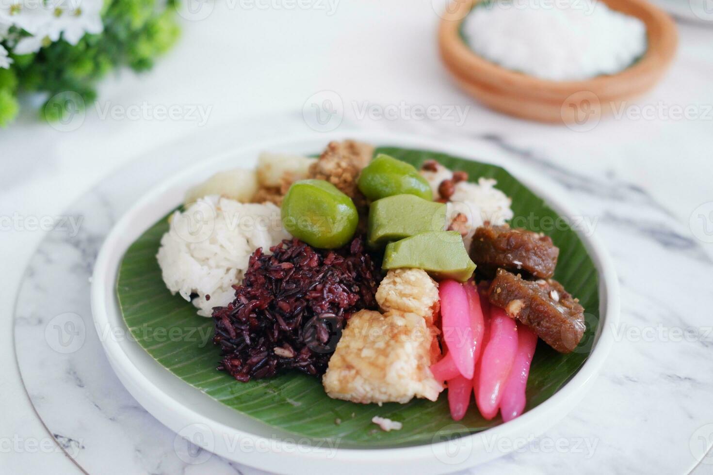 Jenang Madura is a typical Indonesian food that consists of black sticky rice, porridge marrow, jenang grendul and red pearls that were given palm sugar and coconut milk photo